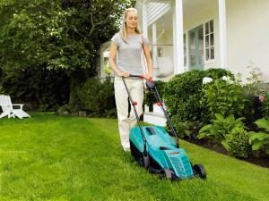 woman with lawn mower