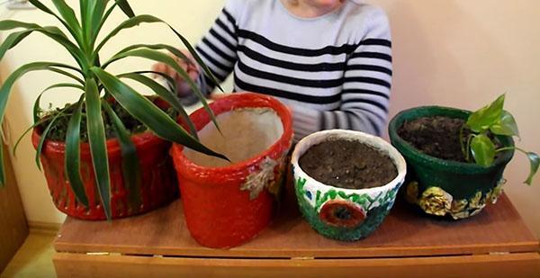 decorating a flower pot with egg trays