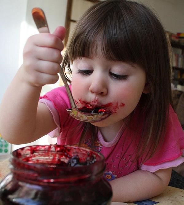 girl eating raspberry jam